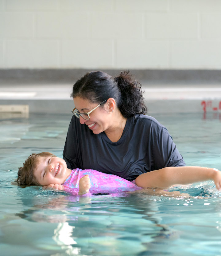 Therapist and young girl in pool