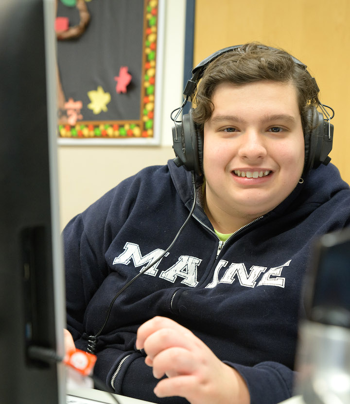 Teen boy at computer with headphones