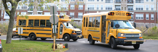 School buses pulling into school lot