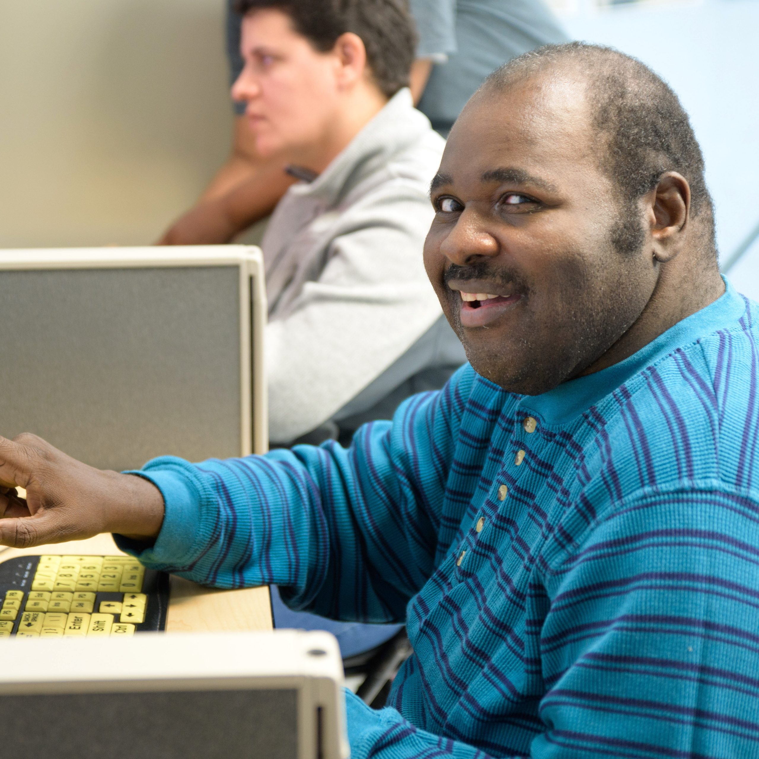 Adult male smiling at computer
