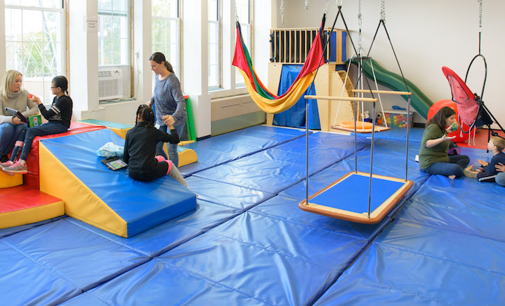 Students and therapists in sensory integration gym